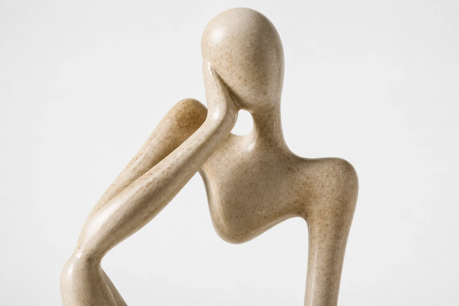 Extreme close-up macro photograph showing the detailed resin texture and smooth finishing of the abstract thinker accent piece